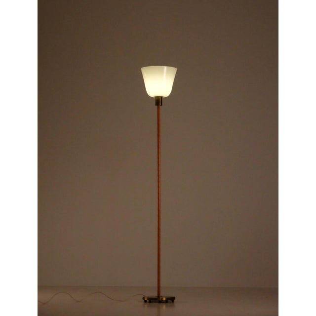 Brass, leather & glass uplight by Nordiska Kompaniet, 1950s. Height: 153 cm. This piece is attributed to the mentioned...