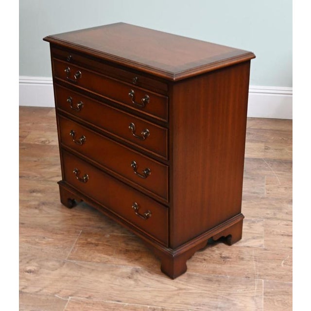 A fine pair of Georgian style mahogany bachelor’s chests of compact and practical proportions Each chest features a...