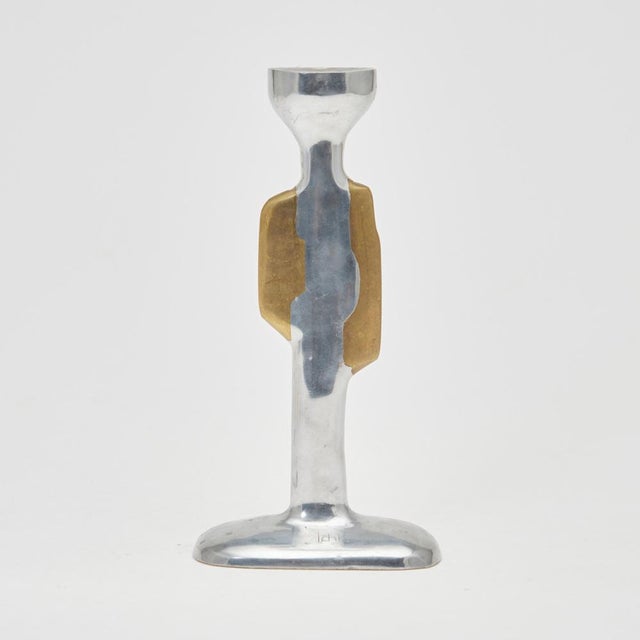 David marshall brutalist candlestick in aluminium and brass. monogram logo on the base, leather protector and...