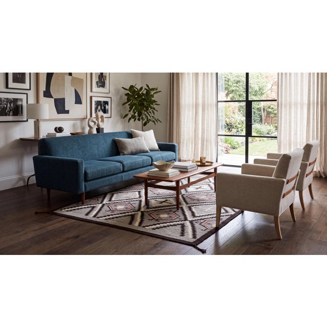 Elevate your living space with this striking modern Navajo-style wool area rug, crafted with exceptional technique and an...