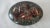 An interesting vintage oval shaped paperweight with various shaped industrial metal shavings from copper, brass and...