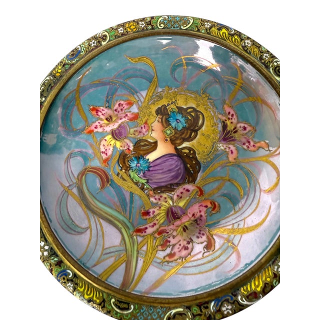 An Art Nouveau style Sevres porcelain & champlevé enamel centerpiece The center of the bowl features a stylized portrait...