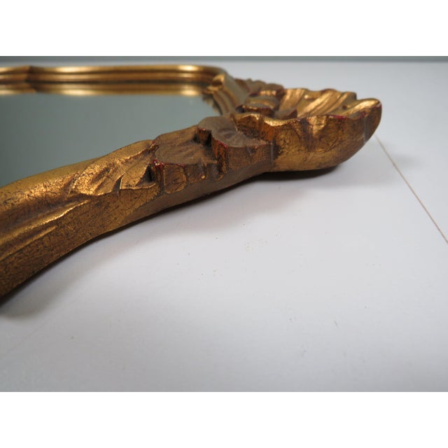 A refined Belgian wall mirror from the 1960s, designed in the glamorous spirit of Hollywood Regency. The sculpted giltwood...