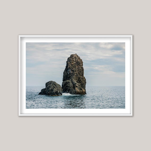 A colour photograph of the Cyclopean Islands near Catania, Sicily. These striking volcanic formations, estimated to be...