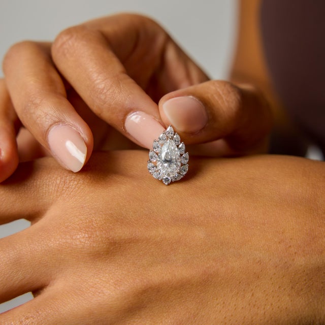 This vintage diamond cluster pendant is a refined statement of brilliance, proportion, and timeless elegance. At its...