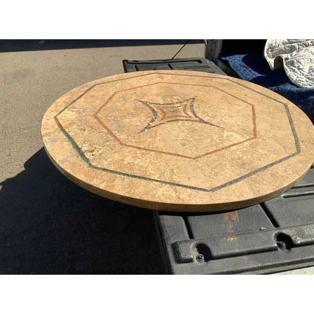 Travertine round table top. Top has an inlaid design in middle. Multi colored. The top is is in excellent condition, no...