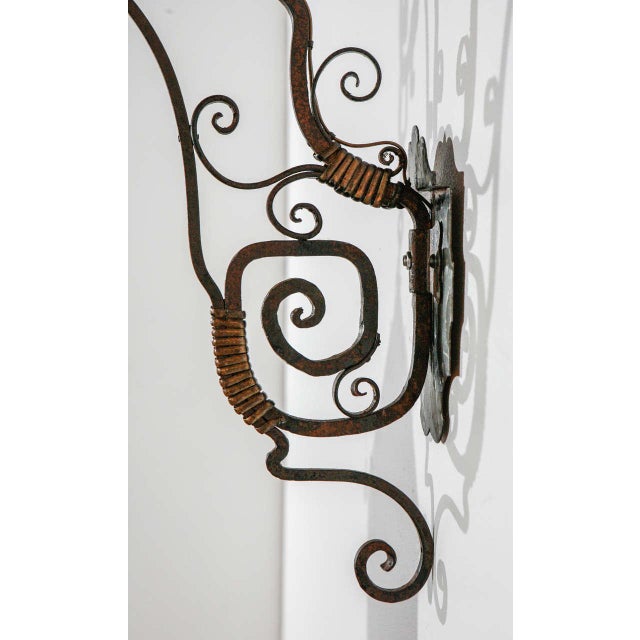 Very large exterior iron sconce with beautiful brass detailing and amber glass in excellent condition. The aged patina has...