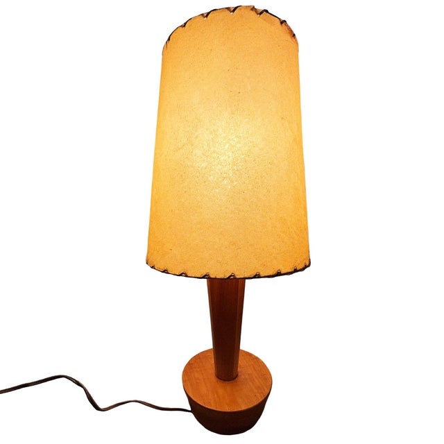 This pair of Yasha Heifetz-designed table lamps features sculptural oak forms enveloping their cylindrical brass supports....