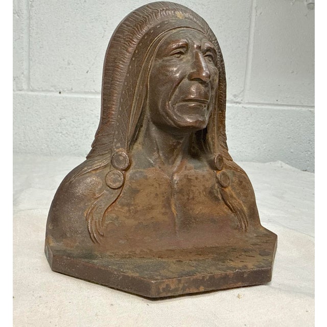 This antique doorstop statue depicts a Native American Indian Chief, showcasing intricate craftsmanship and a historical...