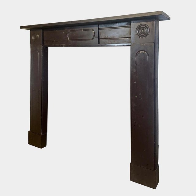 An early 19th century Irish Bangor Slate Antique Regency fireplace. The jambs with shaped moulded panels, separate foot...