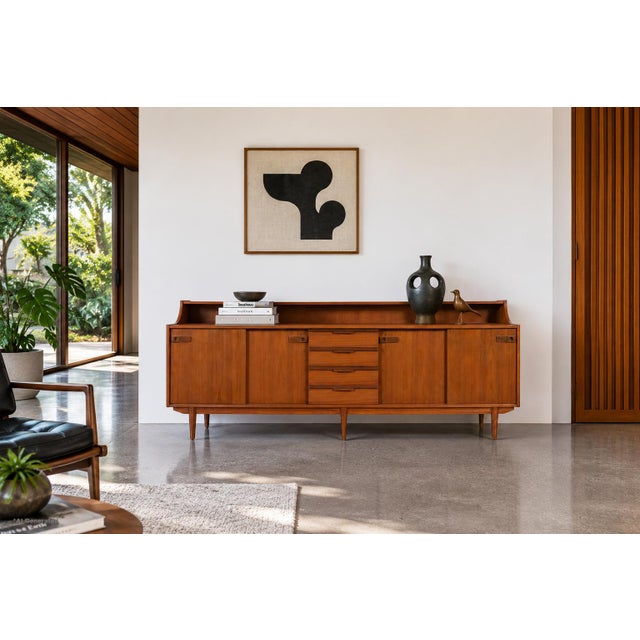 Mid-century modern teak credenza / sideboard manufactured in England during the 1960s. Elegant proportions, thoughtful...
