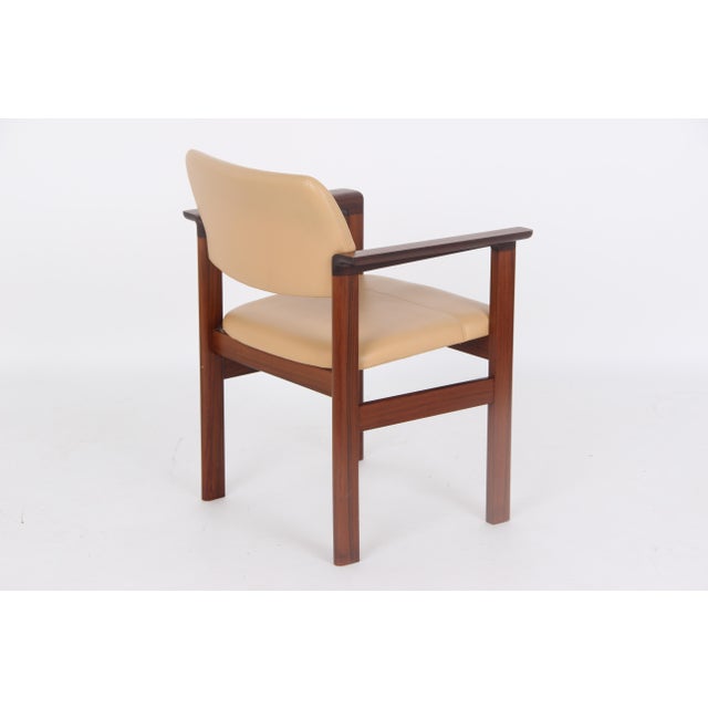 Four very beautiful and comfortable armchairs made of dark wood with light leather upholstery. The armchairs are from...