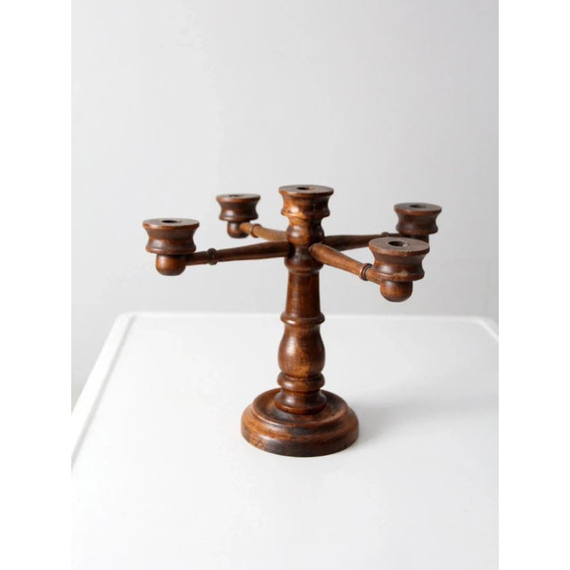 This is a vintage wooden candelabra. The turned wood candlestick holder features four arms and a center pedestal. Lovely...