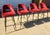 Set of four Eichholtz Avoiro bar stools with red velvet upholstery and a polished designer profile. A striking set for a...