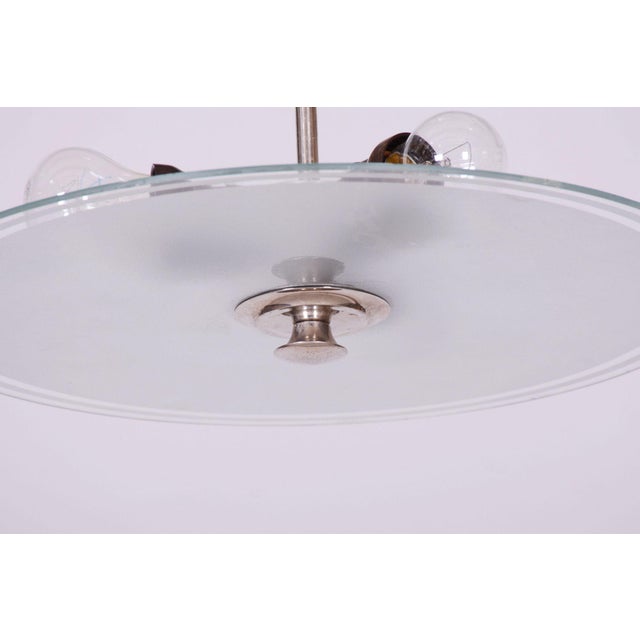 This pendant chandelier, originating from the 1930s, represents a magnificent and highly representative example of...