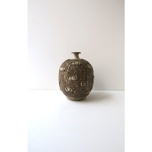 A hand‑thrown stoneware pottery vase, Organic Modern, circa mid to late-20th century (1960s-1970s), America. The vase...