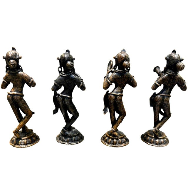 This striking vintage set of four Indian cast brass musician figurines features an elegant traditional folk-art design...