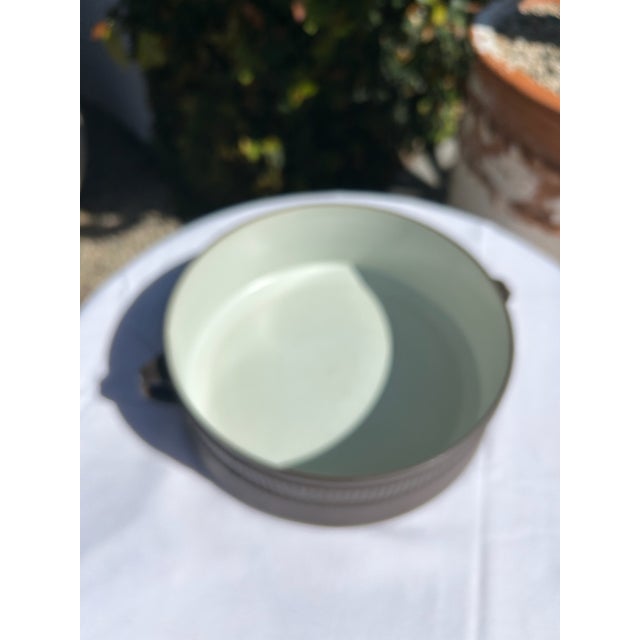Vintage mid-century Dansk serving bowl featuring a clean, sculptural silhouette with integrated side handles and a classic...