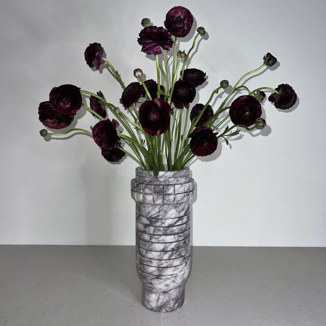 Handcrafted from richly veined white marble, the Array Tall Vase is defined by its elongated silhouette and rhythmic...