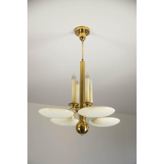 Beautiful large art deco chandelier made of brass plated metal and blown glass ivory color shades. Item was cleaned...
