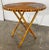 Vintage round collapsible rattan table. Features split reed top and scalloped edge. Sturdy with age wear.