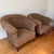 A pair of deep, generously scaled club chairs in the classic English country-house style. Each has a barrel back with...