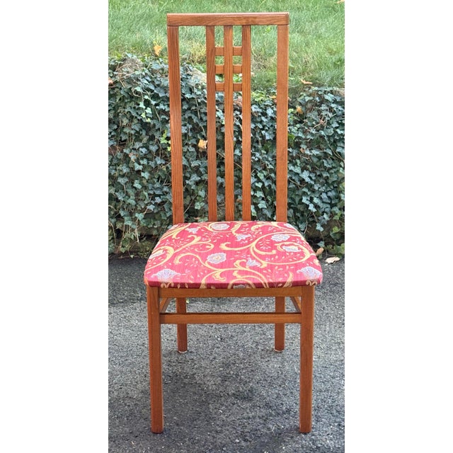 Beautifully crafted in Italy, this striking set of 10 teakwood dining chairs showcases timeless mid-century modern design....