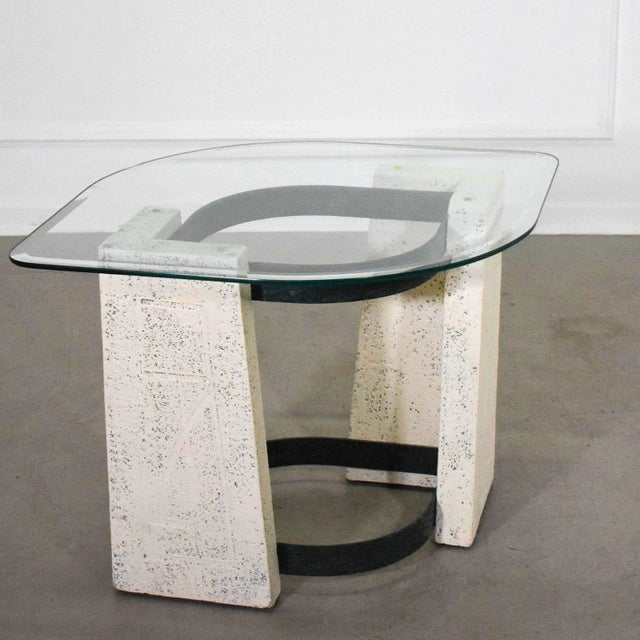 Rare 1960’s eye shaped side table featuring a plaster base with abstract carving details held together by iron with a...