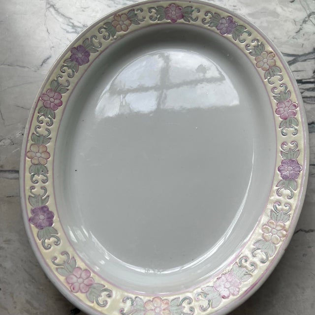 The item is a vintage Chinese porcelain platter with a floral design, likely from Macau. Beautiful hand-painted floral...