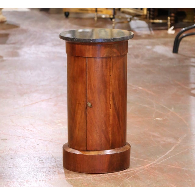 This antique French bouillotte table was crafted circa 1870 in the Empire style and features a rich walnut cylindrical...