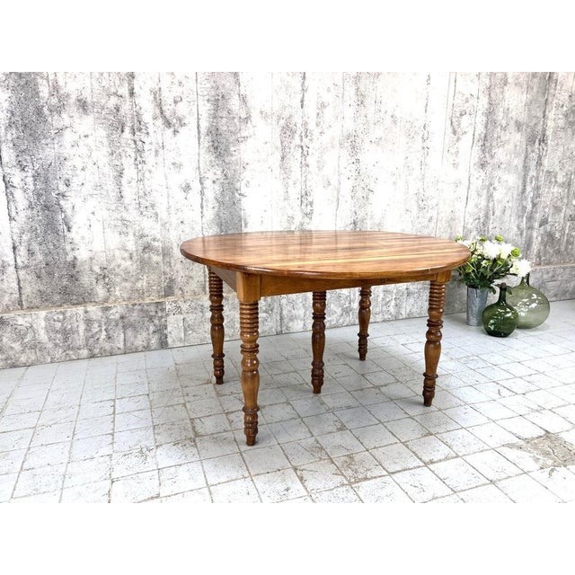 Very beautiful. Classic French drop leaf table, made of a solid satin style wood with deliciously turned bobbin style...