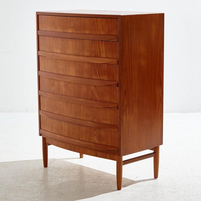 Danish teak dresser with six-drawers and unique handles from the 1970s. The wooden parts of the dresser have been...