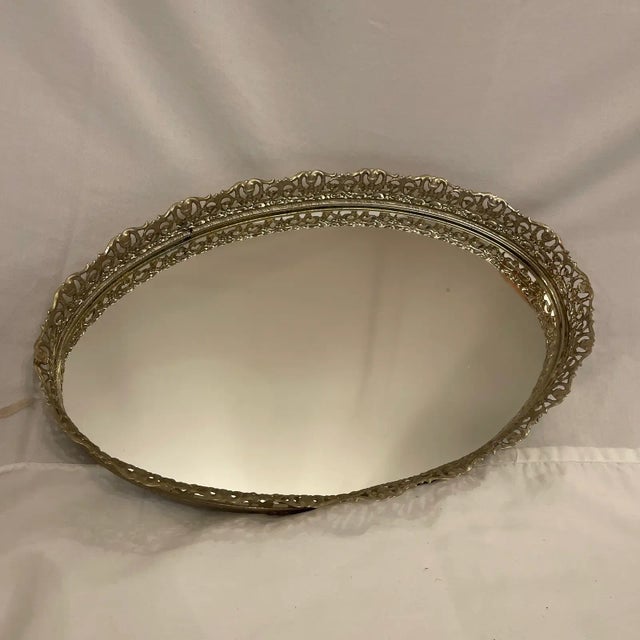 Fabulous Hollywood regency rococo oval pierced brass mirror plateau tray. Perfect for a dressing table vanity or for...