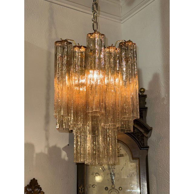 The Murano Fume colored Tronchi Glass Chandelier is an elegant and stylish lighting fixture designed for adults. This...