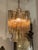 The Murano Fume colored Tronchi Glass Chandelier is an elegant and stylish lighting fixture designed for adults. This...