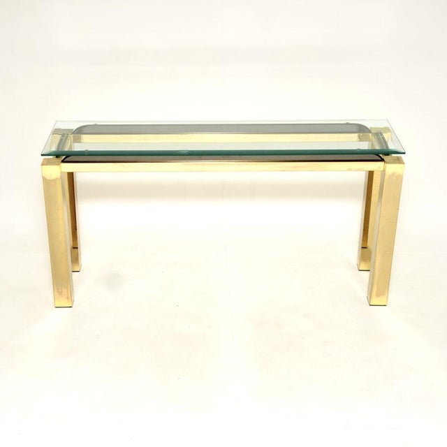 A stylish and very well made vintage Italian brass and glass console side table, dating from the 1970’s. It has a...