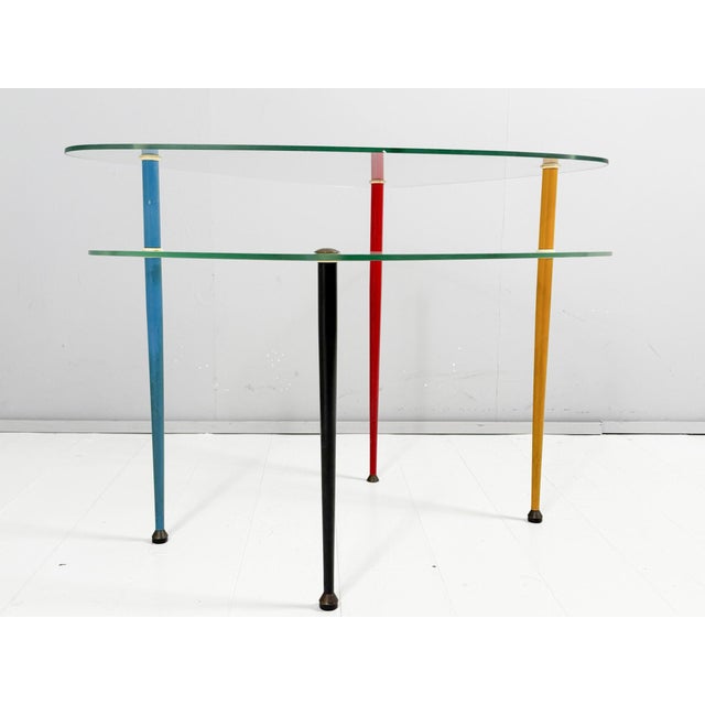Edoardo paoli, model: arlecchino for vitrex, milan/italy, 1950s, four conical tubular steel legs in yellow, blue, red and...