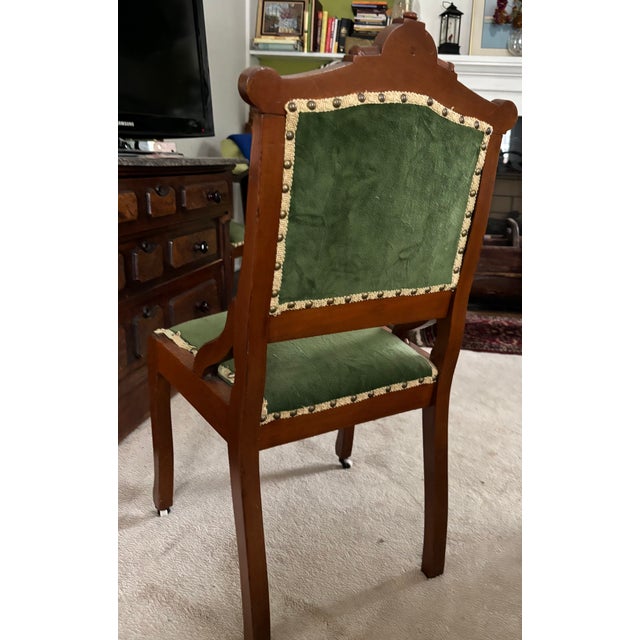 Pair of velvet covered Victorian side chairs. Gold brocade along the edges with brass studs.