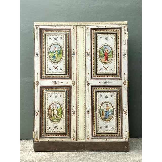 This vintage neoclassical painted wood armoire is a tour de force of decorative artistry, its tall two-door silhouette...