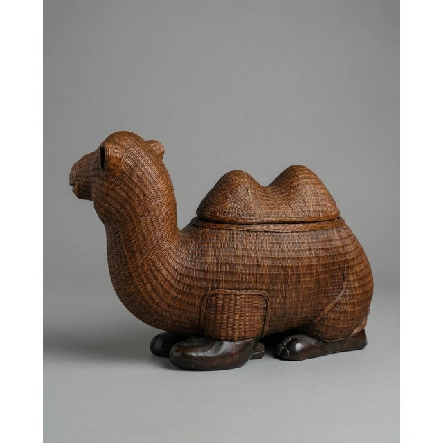 A charming piece of mid-century boho décor, this vintage woven rattan camel is equal parts sculptural and functional....