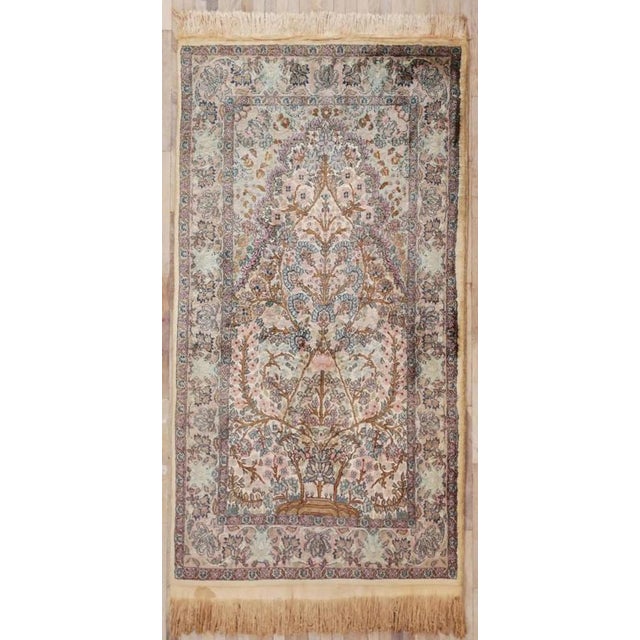 Hand-knotted rug with a beautiful tree of life motif and a rich floral border. The rug is made of silk and wool on a...