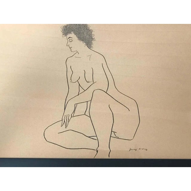 Gracious nude of a woman drawn with ink on craft paper. It is signed by the artist. The artwork sits in a simple black...