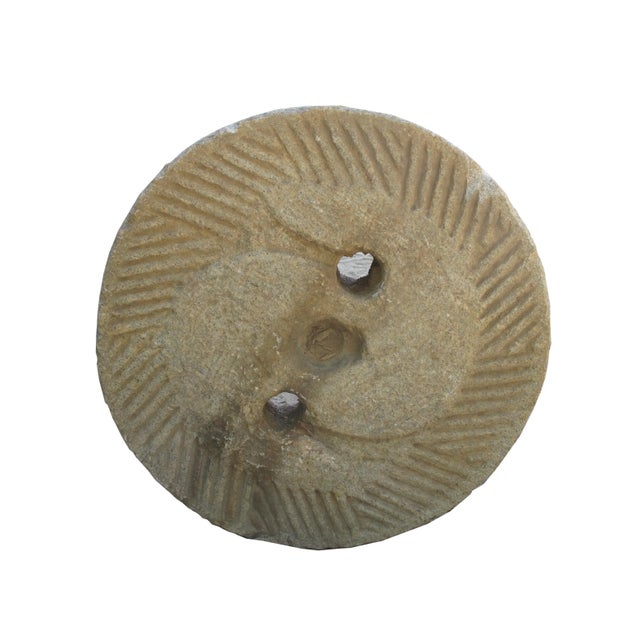 This top of a watermill stone was retrieved from the northern part of China. It was originally used for grinding grains....