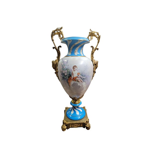 A large Sevres style vase with Ormolu mounts, signed "Danjou". The front depicts a young couple sitting under a tree with...