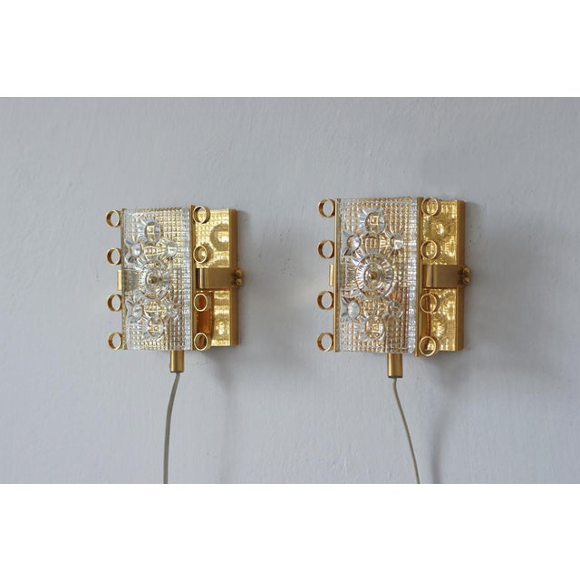This pair of vintage Swedish wall sconces is a perfect example of decorative Scandinavian design from the 1960s and 1970s,...