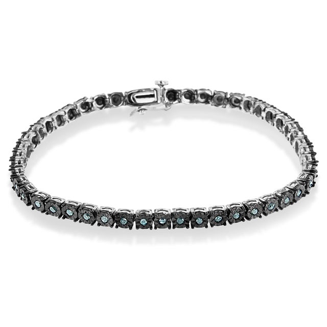 Delve into the depths of elegance with this entrancing blue diamond tennis bracelet, where vintage charm meets...