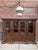 This monumental display cabinet made of solid oak has been fully restored. It features four doors with glass panels in the...