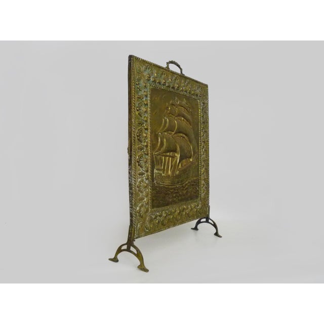 Antique Brass Fire Screen with Sailboat Design. 1960s Embrace timeless style with this stunning vintage fire screen...