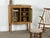 Small oak cabinet by Henning Kjærnulf, dating from the 1960s. The elevated case stands on four boldly shaped legs and is...