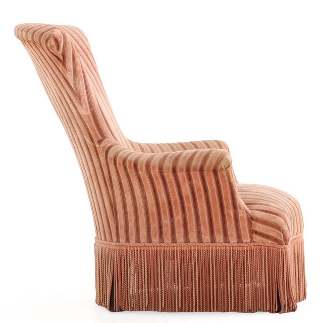 An elegant French Napoleon III armchair dating to circa 1870, crafted in richly figured walnut and upholstered in a...